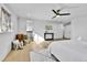 Airy main bedroom features wood floors, a ceiling fan, and walk-in closet at 3930 S Hillcrest Dr, Denver, CO 80237