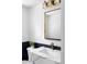 Stylish powder room with marble countertop, gold accents, and elegant lighting at 3930 S Hillcrest Dr, Denver, CO 80237