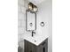 Stylish powder room featuring a modern vanity, sleek fixtures, and a decorative mirror at 3930 S Hillcrest Dr, Denver, CO 80237