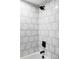 Updated shower stall with white subway tiles and modern fixtures at 3930 S Hillcrest Dr, Denver, CO 80237