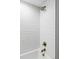 Tiled shower with a large rain shower head and gold fixtures at 3930 S Hillcrest Dr, Denver, CO 80237