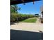 Landscaped backyard with vibrant bushes and lawn leading to additional yard features at 22400 County Road 10, Hudson, CO 80642