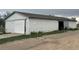 Large white barn with sliding doors and gravel surroundings at 22400 County Road 10, Hudson, CO 80642