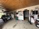 Well-maintained barn interior featuring stalls, a golf cart, and storage at 22400 County Road 10, Hudson, CO 80642