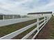 View of a white fenced pasture and the barn at 22400 County Road 10, Hudson, CO 80642