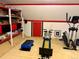 Finished basement with exercise equipment and storage shelves offers versatile space at 22400 County Road 10, Hudson, CO 80642