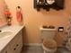 Peach-themed bathroom with decorative accents and a shower at 22400 County Road 10, Hudson, CO 80642
