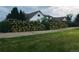Charming home featuring vibrant yellow flowers lining the walkway and a well-maintained lawn at 22400 County Road 10, Hudson, CO 80642