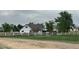 Quaint farmhouse with white fence, mature trees, and a large yard, offering a serene country lifestyle at 22400 County Road 10, Hudson, CO 80642