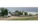 Scenic property with a stone wall, lush greenery, and a long driveway at 22400 County Road 10, Hudson, CO 80642
