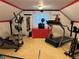 Carpeted home gym with treadmill, elliptical, and stationary bike at 22400 County Road 10, Hudson, CO 80642
