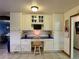 Functional kitchen nook featuring built-in desk and storage areas at 22400 County Road 10, Hudson, CO 80642