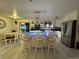 Bright kitchen with an island and bar stool seating, stainless steel appliances, and dining area at 22400 County Road 10, Hudson, CO 80642