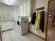 Bright laundry room with new washer and dryer and ample storage cabinets at 22400 County Road 10, Hudson, CO 80642