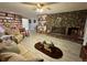 Inviting living room boasts a stone fireplace, unique decor, and comfortable seating area at 22400 County Road 10, Hudson, CO 80642
