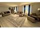 Cozy living room with neutral tones, a decorative rug, and ample seating at 22400 County Road 10, Hudson, CO 80642