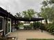 Covered patio area with outdoor seating perfect for entertaining and relaxing at 22400 County Road 10, Hudson, CO 80642