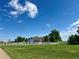 Sprawling country estate featuring a white fence surrounding lush green fields and a charming farm house in the distance at 22400 County Road 10, Hudson, CO 80642