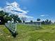 Large grassy area with a fenced dog run or paddock and a storage barn at 22400 County Road 10, Hudson, CO 80642