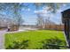 Spacious backyard featuring a manicured lawn, storage shed, and gravel area providing a functional outdoor space at 3680 S Logan St, Englewood, CO 80113