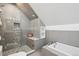 Modern bathroom with glass-enclosed shower with river rock accents, and separate soaking tub at 3680 S Logan St, Englewood, CO 80113