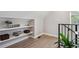 Bright loft area with decorative shelving, hardwood floors and view out the window at 3680 S Logan St, Englewood, CO 80113