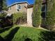 A cozy backyard featuring a well-maintained lawn, trimmed hedges, and an inviting outdoor space at 1927 Rannoch Dr, Longmont, CO 80504