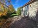 Backyard featuring a brick patio, lush green lawn, and privacy landscaping at 1927 Rannoch Dr, Longmont, CO 80504