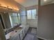 Bright bathroom featuring double sinks, granite countertops, and modern lighting fixture at 1927 Rannoch Dr, Longmont, CO 80504