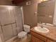 Bathroom featuring a glass-door shower, tile floors, and a vanity with a framed mirror at 1927 Rannoch Dr, Longmont, CO 80504