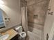 Bathroom featuring granite countertop, oval mirror, and tiled shower with storage niche at 1927 Rannoch Dr, Longmont, CO 80504