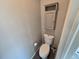 Small bathroom featuring a toilet, a storage cabinet, and gray paint at 1927 Rannoch Dr, Longmont, CO 80504