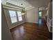 Elegant dining room featuring hardwood floors, tray ceilings, and large windows at 1927 Rannoch Dr, Longmont, CO 80504