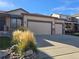 Home with an attached two car garage, desert landscaping, and a concrete driveway at 1927 Rannoch Dr, Longmont, CO 80504