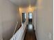 Hallway upstairs with wood floors and white railings at 1927 Rannoch Dr, Longmont, CO 80504