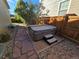 Backyard featuring a modern hot tub in a gravel-lined alcove with stepping stone paver access at 1927 Rannoch Dr, Longmont, CO 80504