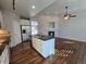Spacious kitchen with an island, stainless steel appliances, and wood flooring at 1927 Rannoch Dr, Longmont, CO 80504