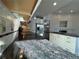 Gourmet kitchen with granite countertops, stainless steel appliances, and tiled backsplash at 1927 Rannoch Dr, Longmont, CO 80504