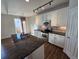 Modern kitchen with a large island, stainless steel appliances, and wooden floors at 1927 Rannoch Dr, Longmont, CO 80504