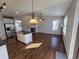 Open concept living room and kitchen with stainless steel appliances, fireplace, and hardwood floors at 1927 Rannoch Dr, Longmont, CO 80504