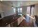 Open-concept living area featuring hardwood floors, vaulted ceilings, and natural light from large windows at 1927 Rannoch Dr, Longmont, CO 80504