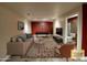 Staged living room boasting modern furniture and decor plus an open view to the renovated bathroom at 1927 Rannoch Dr, Longmont, CO 80504