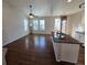 Open-concept living space with hardwood floors, modern lighting, and large windows for natural light at 1927 Rannoch Dr, Longmont, CO 80504