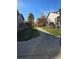 A street view of a sidewalk in front of houses and beautiful autumn colored trees at 1927 Rannoch Dr, Longmont, CO 80504