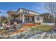 Backyard patio with pergola, outdoor seating and firepit on a sunny day at 2272 Front Range Rd, Erie, CO 80516