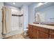 Traditional bathroom offers a combined shower-tub, neutral color scheme, and a vanity with a large mirror at 2272 Front Range Rd, Erie, CO 80516