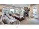 Cozy living room featuring a fireplace, large sectional sofa, and plenty of natural light at 2272 Front Range Rd, Erie, CO 80516