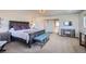 Spacious main bedroom features a stylish bed, bench, and a decorative cabinet with a mounted TV at 2272 Front Range Rd, Erie, CO 80516