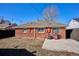 Brick home with a spacious backyard featuring a grill and patio perfect for entertaining at 1680 Syracuse St, Denver, CO 80220