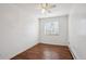 Clean bedroom with wood floors, ceiling fan, and a bright window at 1680 Syracuse St, Denver, CO 80220